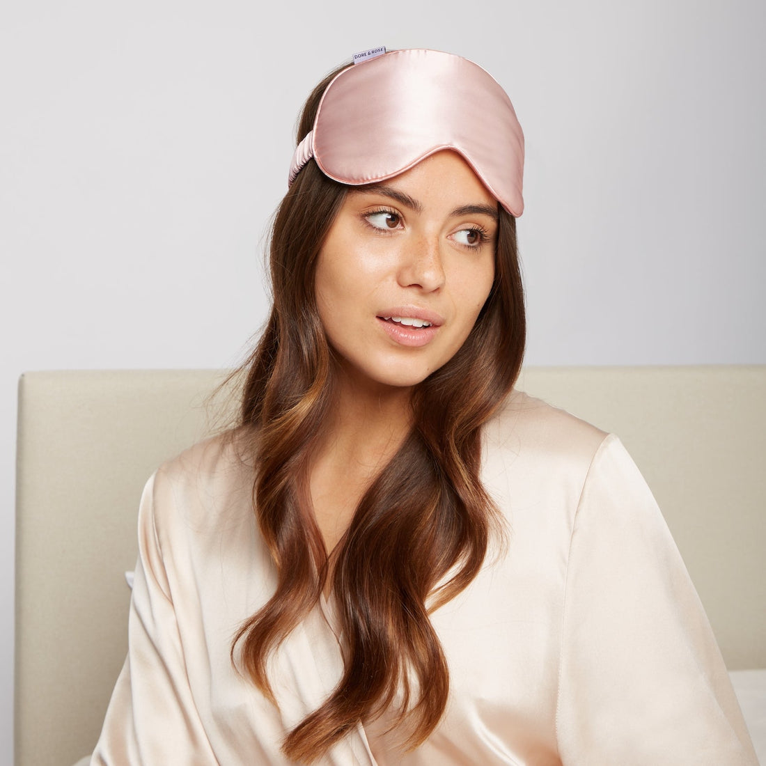 Girl with rose silk soft sleep mask on bed